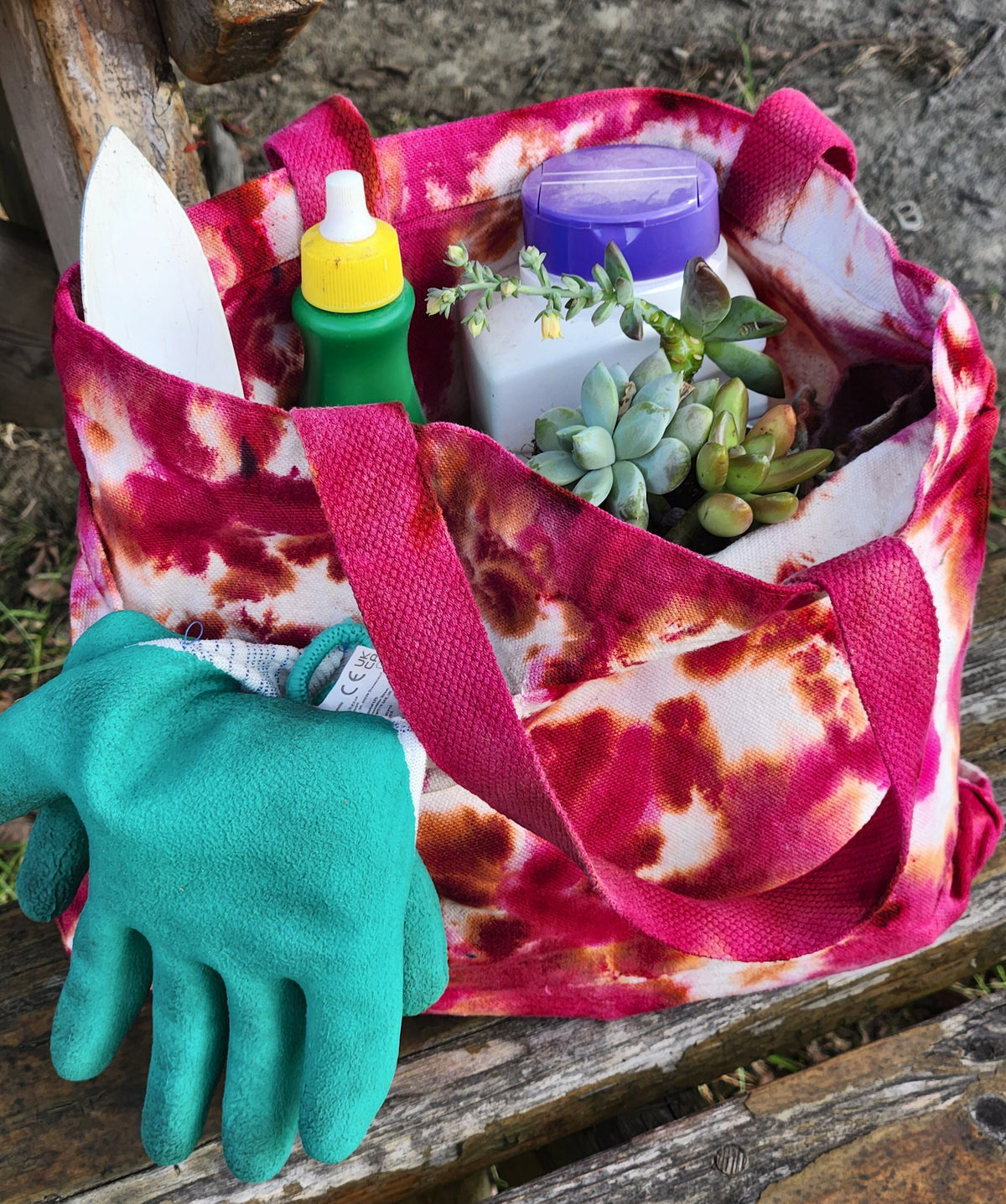 Two fan design tie-dye tote bags.  One blue and purple, the other, orange and pink.