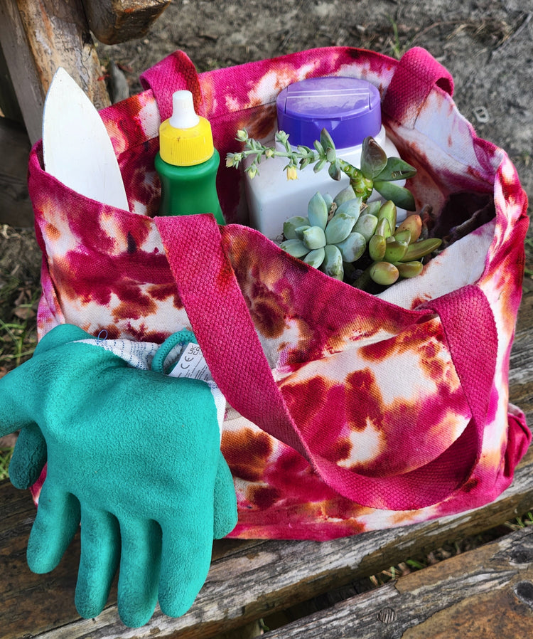 Two fan design tie-dye tote bags.  One blue and purple, the other, orange and pink.