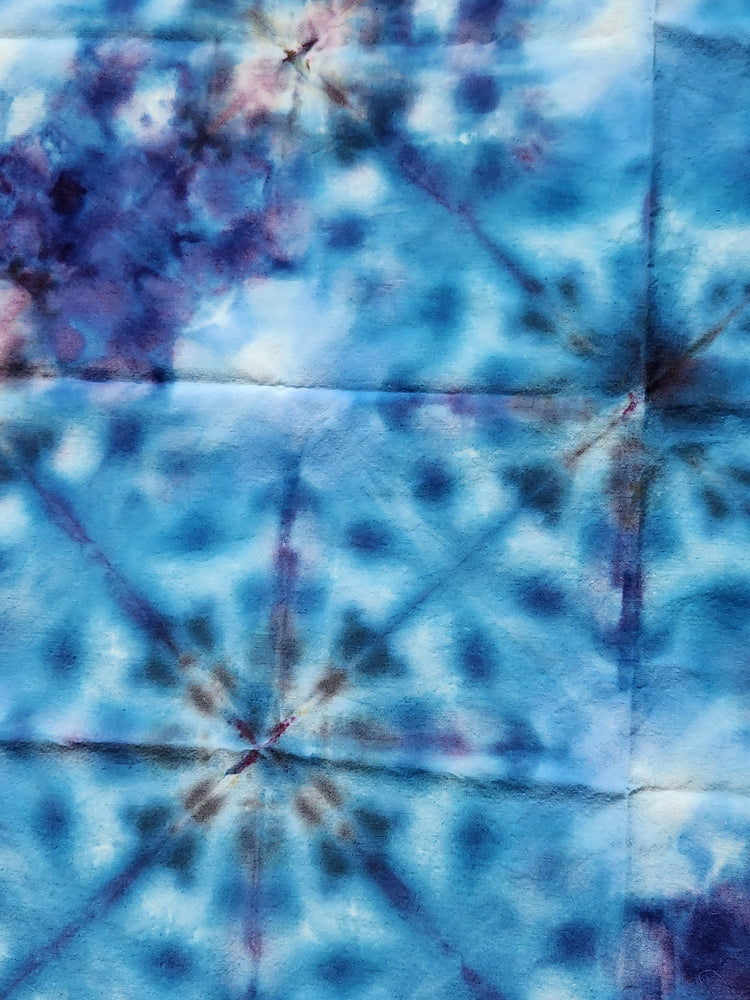Close up of a blue tie-dye bandana.